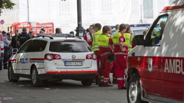 Ambulance drivers and police stand outsi