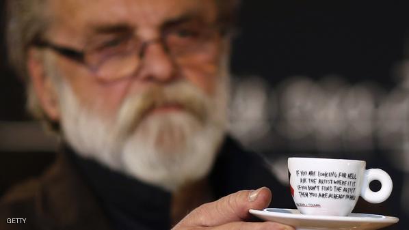 Sarajevo-born artist Dean Jokanovic Toumin, designer of a special edition illy coffee cup, holds up one of the cups, in the ARS AEVI museum of contemporary art in Sarajevo