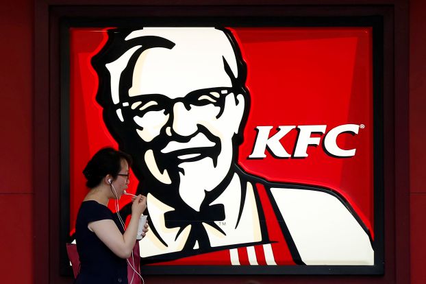 A customer walks past a KFC store in Shanghai