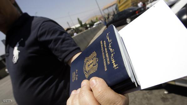 A Syrian man carries passports of relati