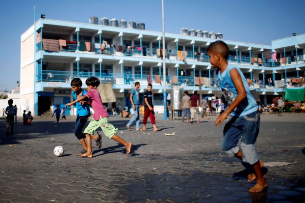 Palestinian boys, who fled houses following Israeli offensive, play soccer as they take refuge at a United Nations-run school in Jabaliya refugee camp in the northern Gaza Strip