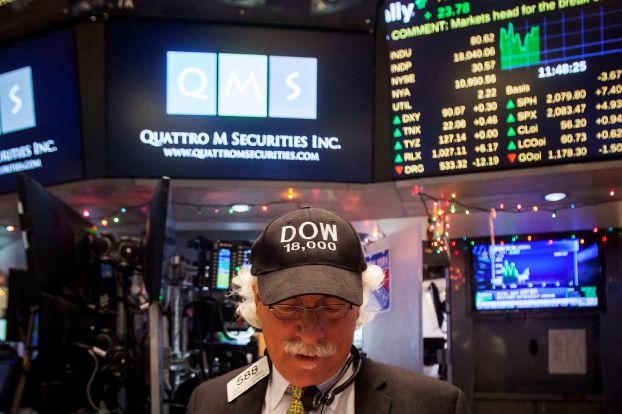 Trader Peter Tuchman wears a "Dow 18,000" cap as he works on the floor of the New York Stock Exchange in New York