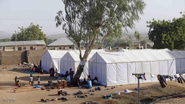 People displaced as a result of Boko Haram attacks in the northeast region of Nigeria, are seen near their tents at a faith-based IDP camp in Yola