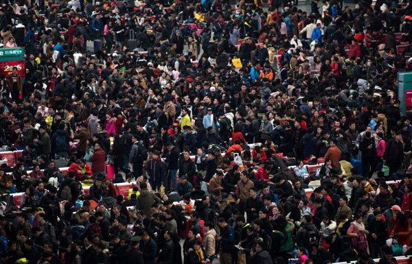 Passengers crowd the Shanghai Hongqiao railway station as they wait to board their trains to head to their hometowns for the Lunar New Year holiday, in Shanghai on February 3, 2016. Over 2.9 billion trips will be made around China during the 40-day "Spring Festival" travel rush, which kicked off on January 24, Chinese authorities estimated. The Spring Festival, this year being the Year of the Monkey, China's most important holiday centering around family reunions, will fall on February 8. AFP PHOTO / JOHANNES EISELE / AFP / JOHANNES EISELE (Photo credit should read JOHANNES EISELE/AFP/Getty Images)