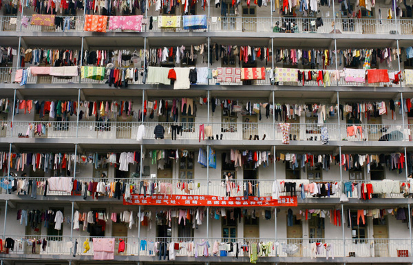 Laundry hangs outside a student dormitory at a college in Wuhan, Hubei province in this March 5, 2009 file photo. Down-at-heel Xiaojiahe in Beijing's university district seems an unlikely haven for China's aspiring elite, but its reeking alleys and dank rooms offer a low-budget bolthole for graduates battling to find work. To match feature CHINA-GRADUATES/ REUTERS/Stringer/Files (CHINA EDUCATION SOCIETY IMAGE OF THE DAY TOP PICTURE) CHINA OUT. NO COMMERCIAL OR EDITORIAL SALES IN CHINA - RTXCNY7